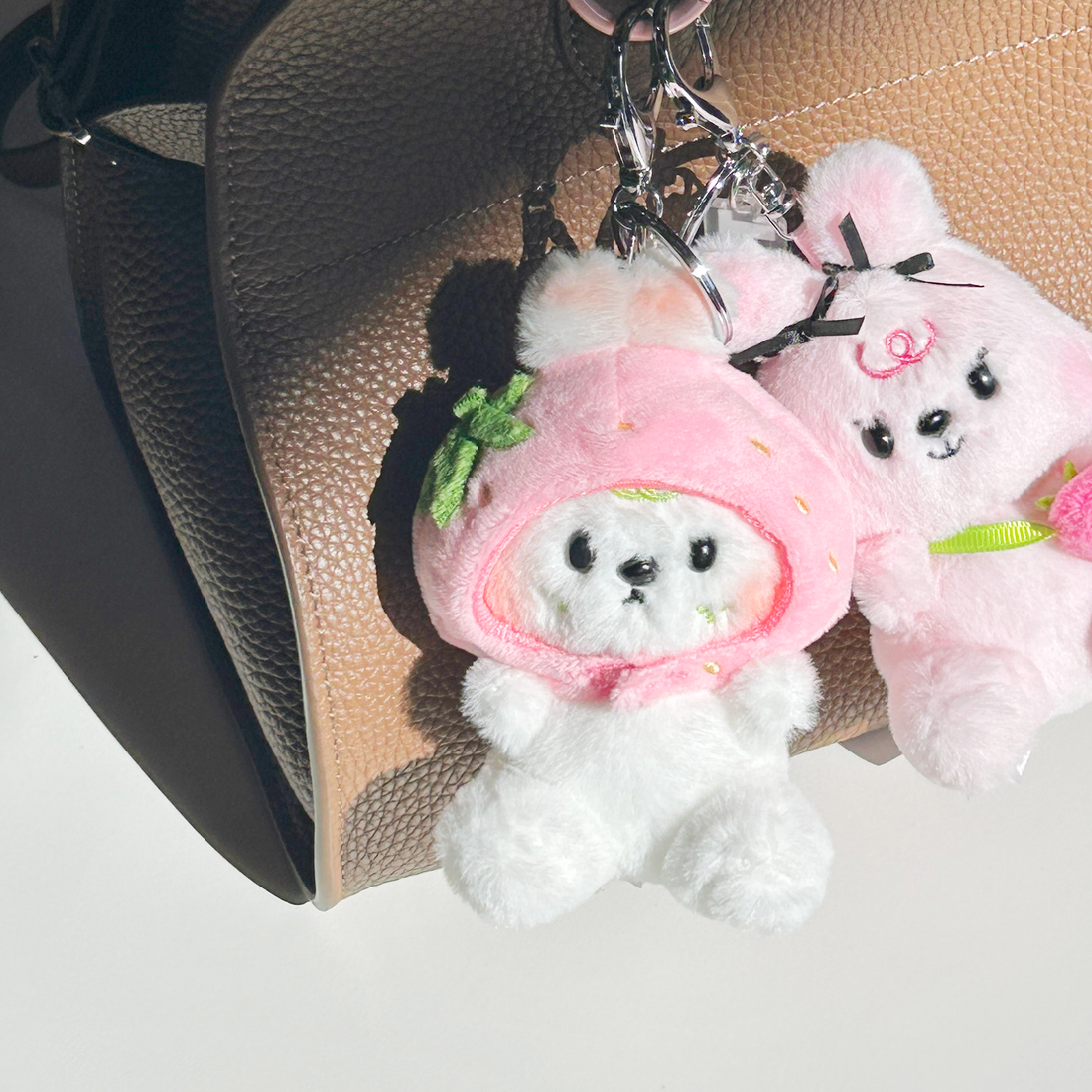 Otto plush ketchain attached to bag in lifestyle setting