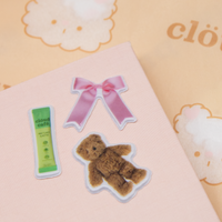 Sticker of a teddy bear and a pink bow on a pink background