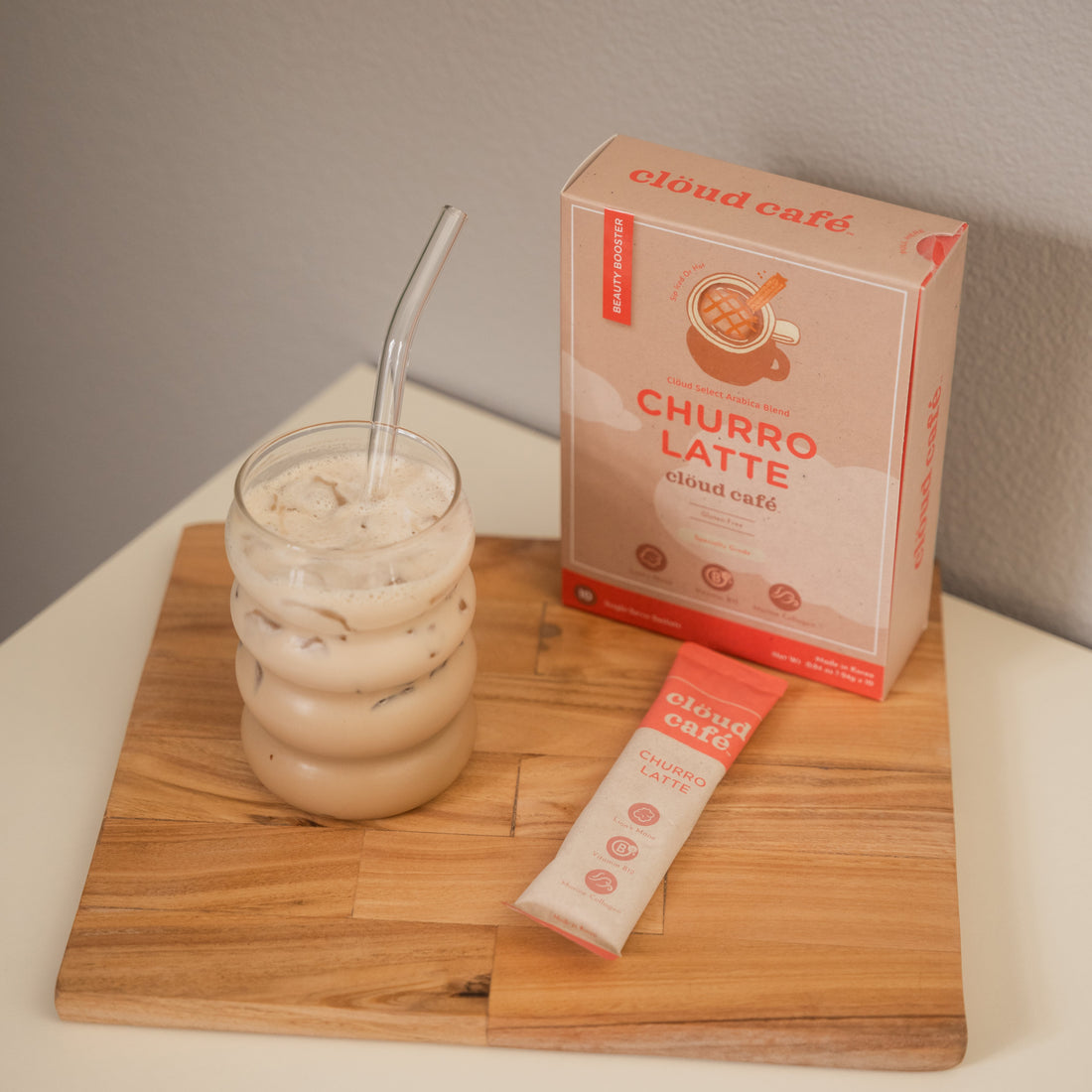 Churro Latte in a cute glass cup and glass straw.