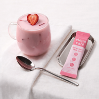 clöud café strawberry milk zero sachet and a cup filled with strawberry milk zero behind a white background