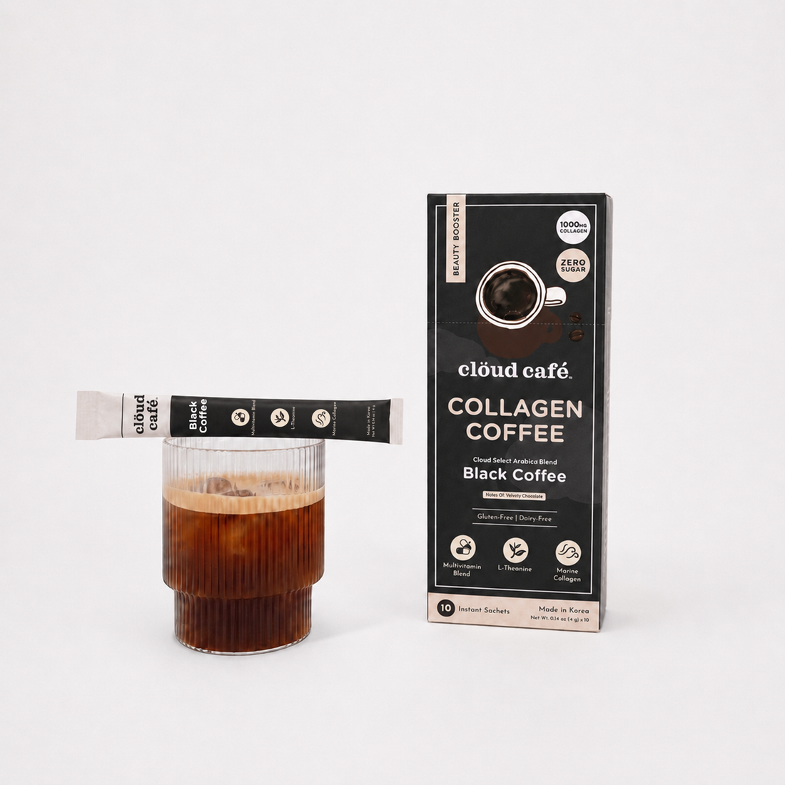 Clöud Café Collagen Black Coffee instant sachet balancing on ribbed glass of iced black coffee next to product box, featuring 1000mg marine collagen, L-theanine, and multivitamin blend, zero sugar gluten-free dairy-free Korean instant Arabica blend with velvety chocolate notes, 10 count.