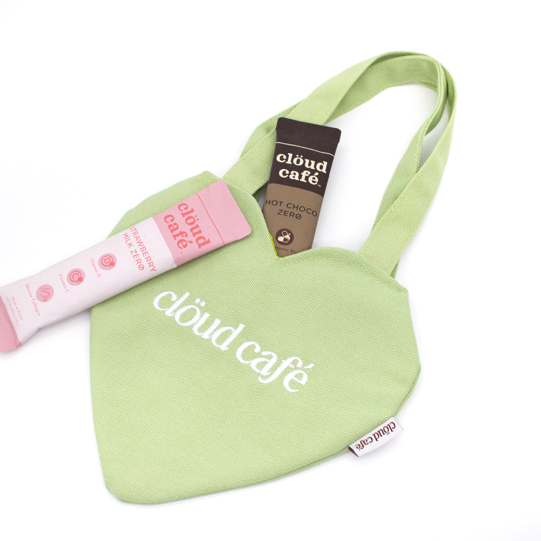 Light pastel green canvas mini heart tote bag with white embroidered logo.