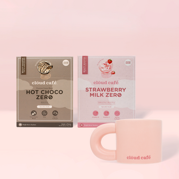 Two Cloud Café drink mixes, 'Hot Choco Zero' and 'Strawberry Milk Zero', with a pink mug on a light pink background.