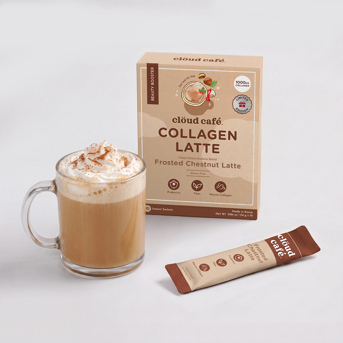 Cloud café Frosted Chestnut Latte instant sachet beside a white mug of latte with cinnamon-dusted latte art, made with Marine Collagen, Probiotics, and Fiber