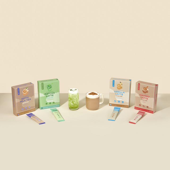 Full collection of Clöud Café packaging boxes and single sachets. Flavors include Royal Milk Tea, Matcha Latte, Vanilla Latte, and Churro Latte.