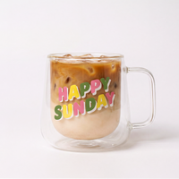Clear "Happy Sunday" mug filled with Clöud Café collagen iced coffee behind a white background