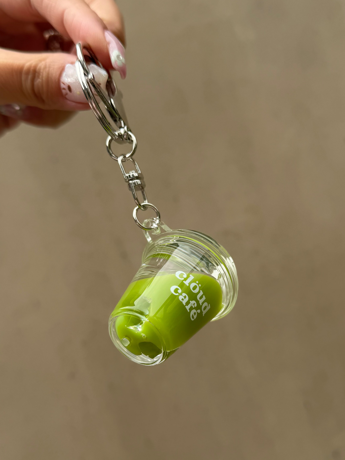Mini iced matcha latte keychain with silver lobster clasp, clear acrylic cup charm, and “clöud café” logo – realistic shaker drink accessory with floating ice cubes for keys, purses, and bags.