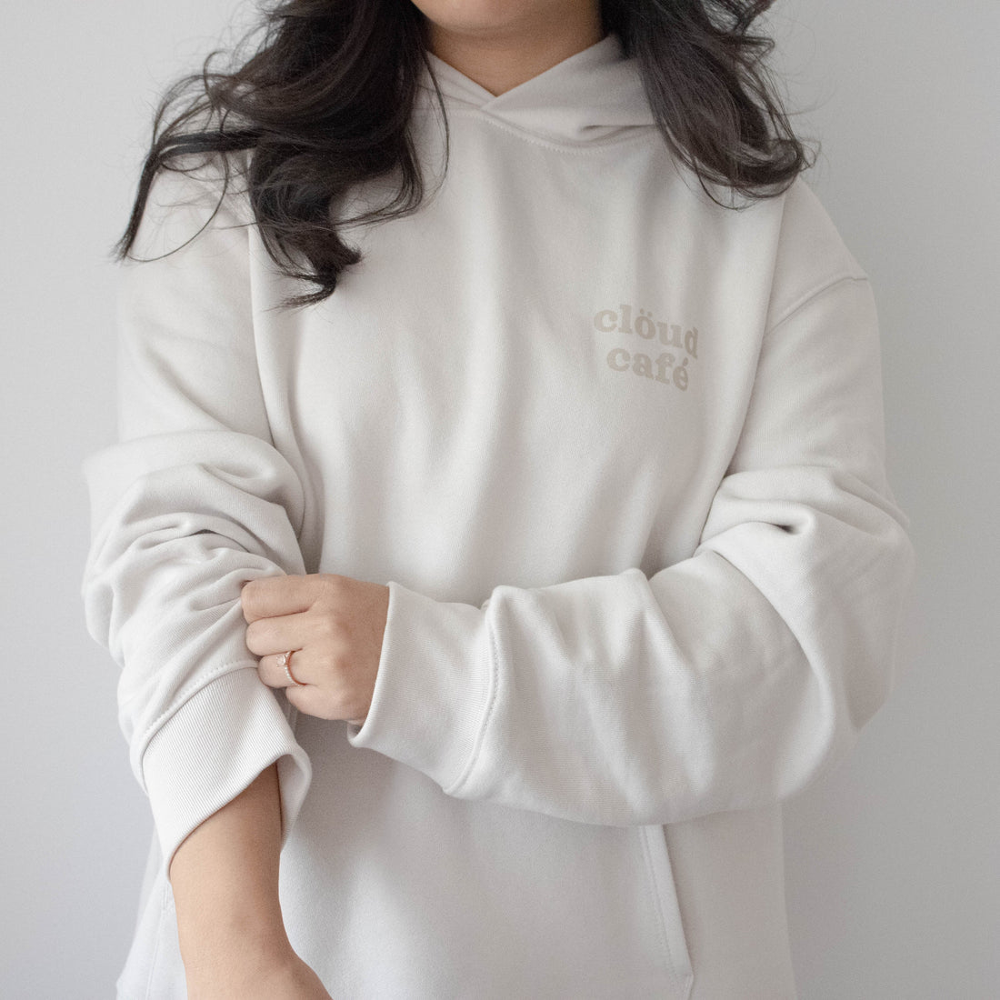 Front of tan-cream hoodie, with "clöud café" logo.