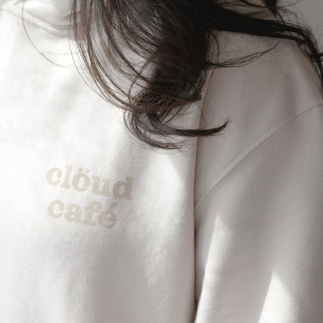 Front of hoodie with "clöud café" logo.