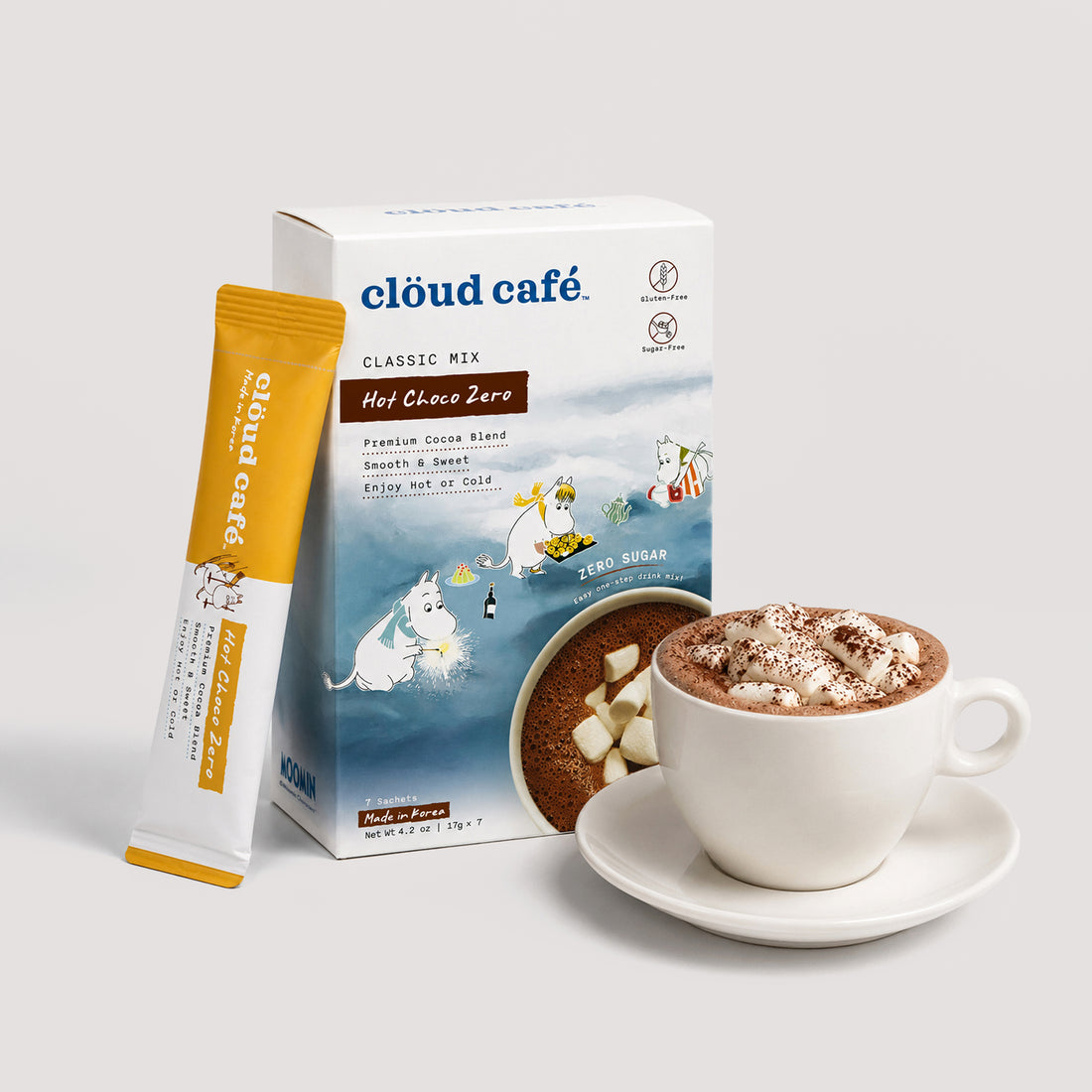 Clöud Café x Moomin Classic Mix Hot Choco Zero instant sachet box with hot chocolate topped with mini marshmallows (not included) and cocoa powder in white ceramic cup and saucer, zero sugar gluten-free smooth and sweet Korean instant premium cocoa blend enjoy hot or cold, 7 sachets. Made in Korea.