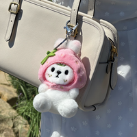 Otto plush keychain attached to bag in lifestyle setting