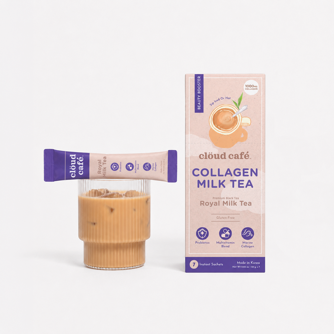 Clöud Café Collagen Royal Milk Tea instant sachet balancing on ribbed glass of iced milk tea next to product box, featuring 1000mg marine collagen, probiotics, and multivitamin blend, gluten-free Korean instant premium black tea, 7 count.