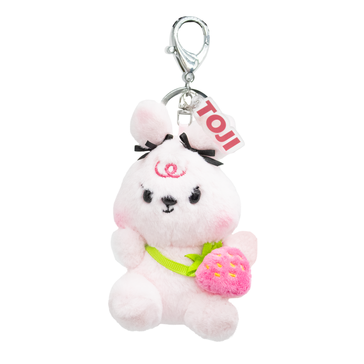 Light pink plush bunny keychain with a bows on ears and a small pink strawberry purse. 