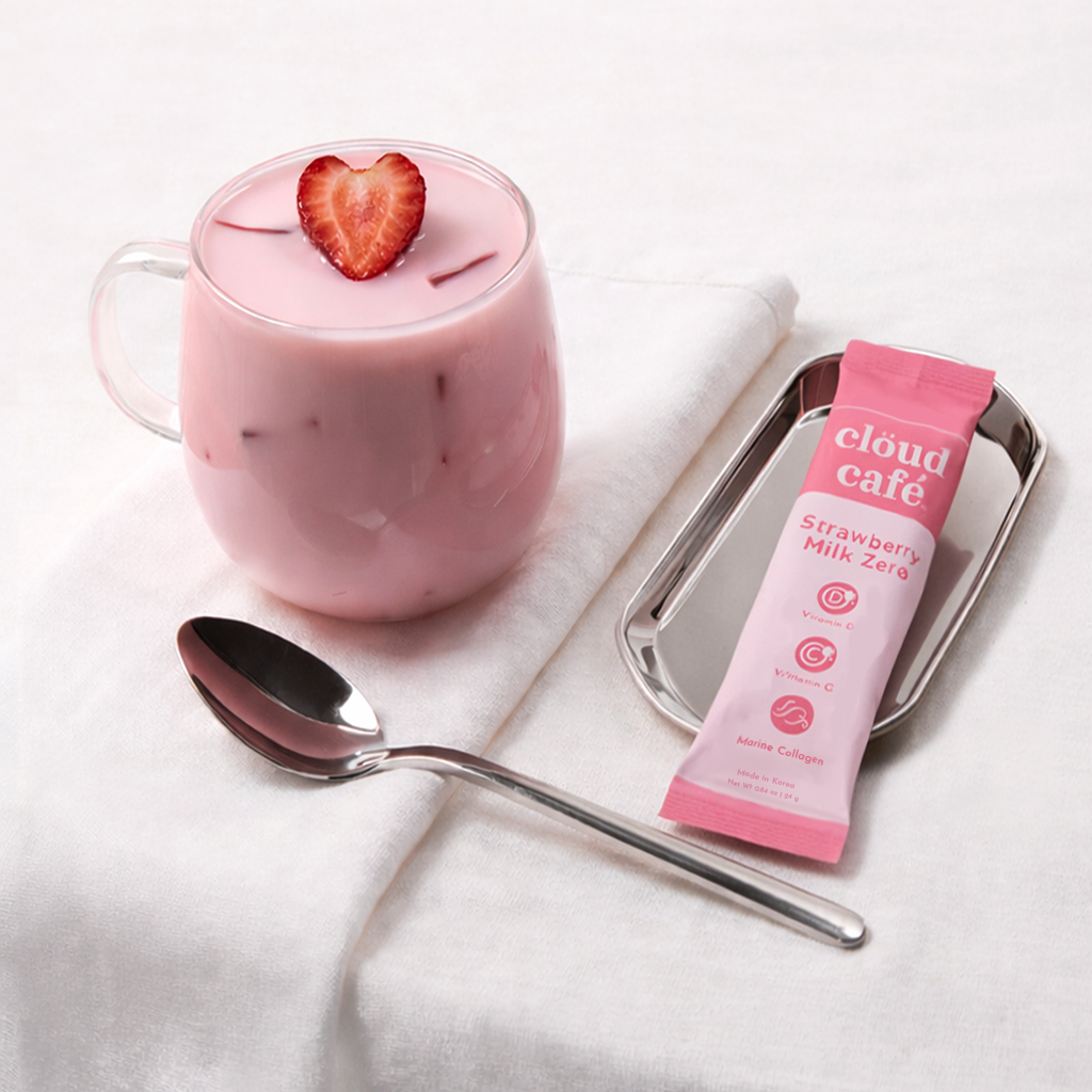 clöud café strawberry milk zero sachet and a cup filled with strawberry milk zero behind a white background