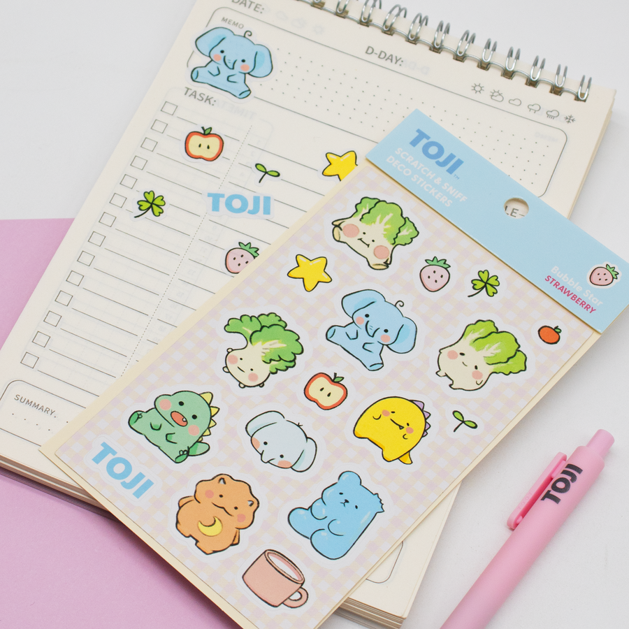 Sticker sheet with cute animal illustrations on a notebook with a pen