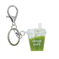 Mini iced matcha latte keychain with silver lobster clasp, clear acrylic cup charm, and “clöud café” logo – realistic shaker drink accessory with floating ice cubes for keys, purses, and bags.