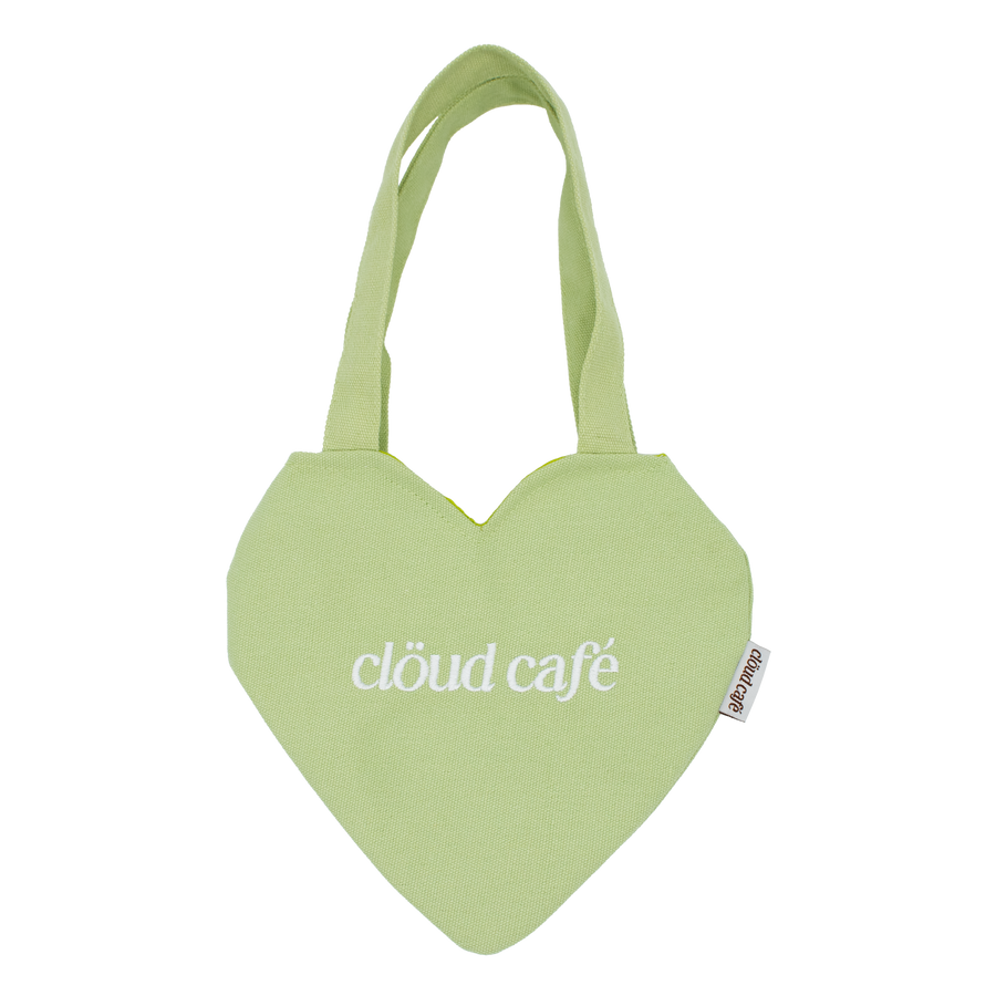 Light pastel green canvas mini heart tote bag with white embroidered logo.