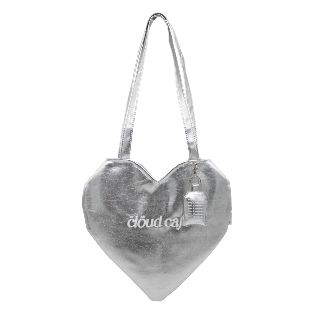 Silver heart-shaped tote bag with long over-the-shoulder strap. White Cloud Cafe embroidered logo. 